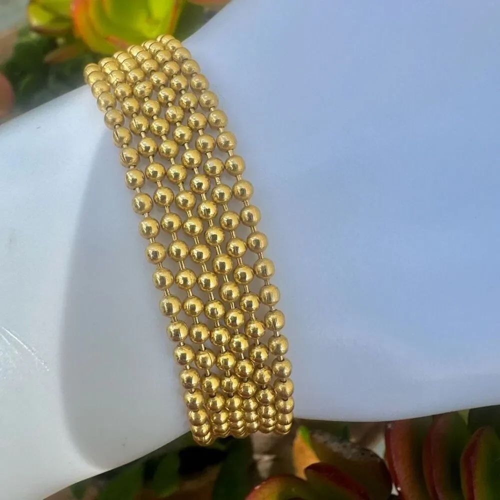 Gold tone multi chain tassel bracelet